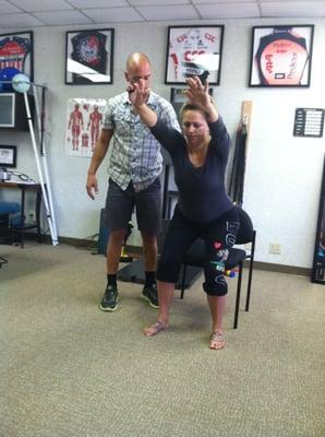 Dr. Rich working on proper squatting technique with a patient to help correct a movement pattern and relieve pain.