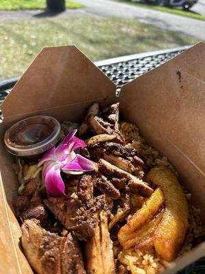 Jerk chicken with rice and peas, stir fried cabbage and sweet plantains