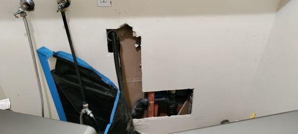 The plumber made a hole in the wall to access the pipes