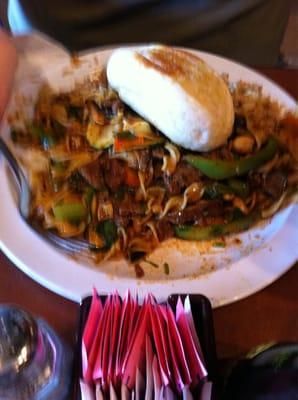 Beef and sausage over egg noodles and fried rice.