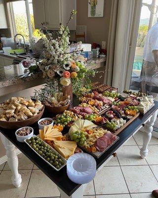 Charcuterie with floral arrangement.