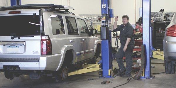 Michael getting ready to lift up an SUV with his hoist