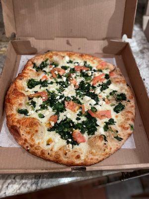 White pie with garlic, spinach tomato and ricotta