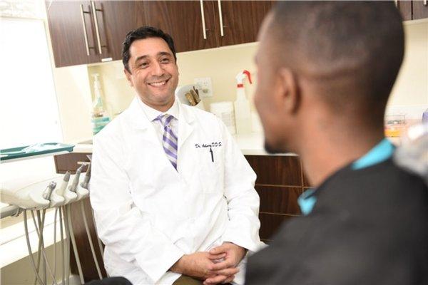 Dr Achury listening to his patient