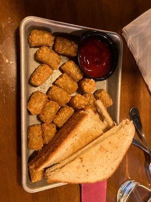 Kids grill cheese and tots.