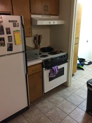 Tiny kitchen-old oven and dishwasher, no garbage disposal, clogged sink, AND not one, not two, but THREE broken cabinets