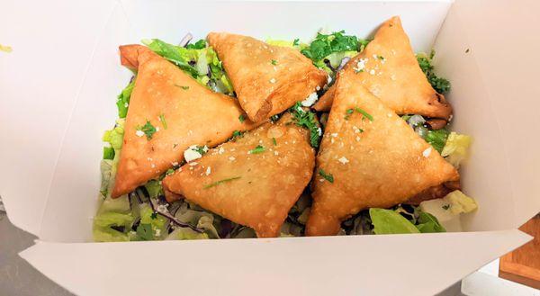 Sambusas, crispy and filled with seasoned veggies.