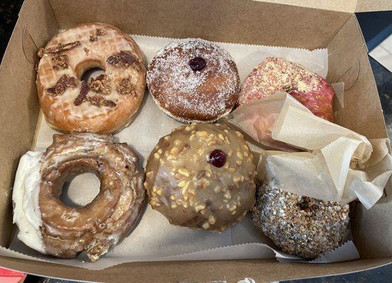 Top left clockwise: Maple Bacon; Jelly; Vegan Cranberry Corn Crumble; Chocolate Chip Old Fashioned; PB&J; and Vegan German Chocolate