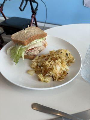 Tuna salad sandwich with hash browns.