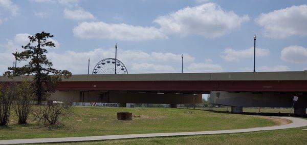 Overpass, path, and Ferris wheel from the park's parking lot