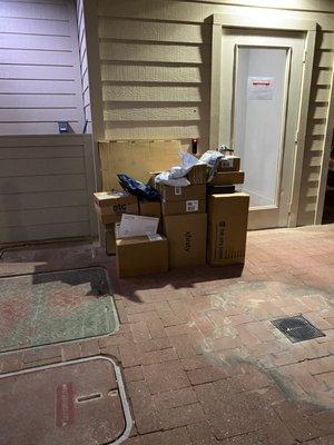 Packages left outside of the package room because it is inaccessible after the office staff leave for the day.  Photo taken at 8:55pm.