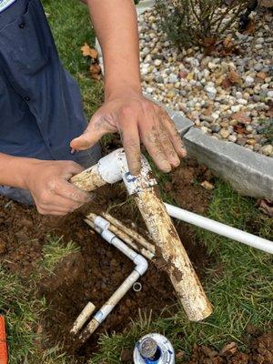 Performance employee showing where the damage was done by the termite employee after trying to drive the big stake into the ground.