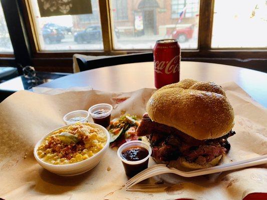 This is the MVP 15 sandwich (brisket, sausage, pulled pork and topped with burnt ends) and a side of smoked elotes.