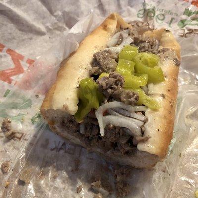 Cheesesteak with added raw onion and mild peppers, extra sub dressing. So good.