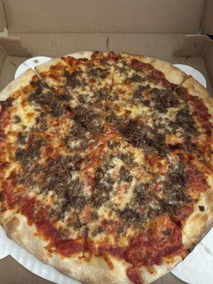 This is a picture of a large steak pizza.