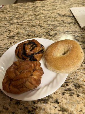 Chocolate roll, cinnamon roll and their bagel coated in corn meal.