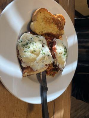 Chicken Parmesan with garlic bread.