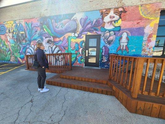 Outside the shop, awesome handicap ramp and Muriel.