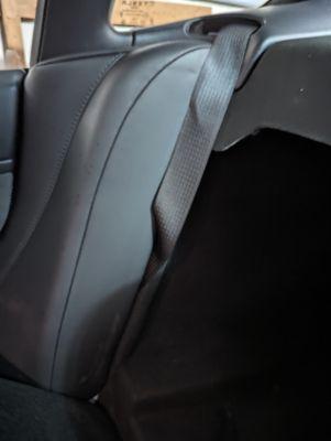 Broken side bolster placed back on top of seatbelt