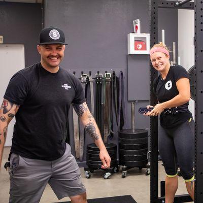 Coach Jeff celebrates with Lifter Elsa as she hits a personal record on the squat.