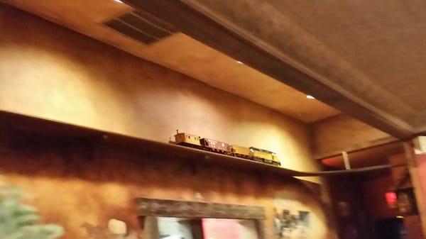 They have a model train running around the ceiling.