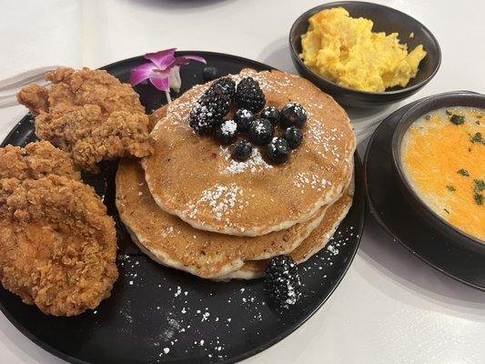 Pancakes with blueberries, cheese eggs, and cheesy grits