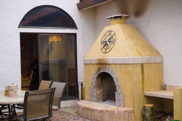 Patio dining with a fireplace