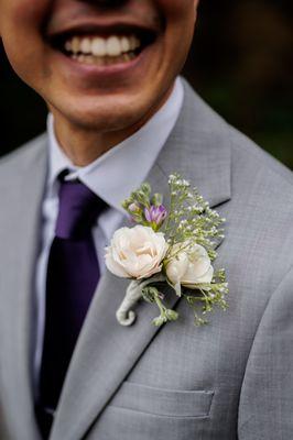 My husband's boutonniere (purple hoary stock, white spray roses, million star baby's breath)