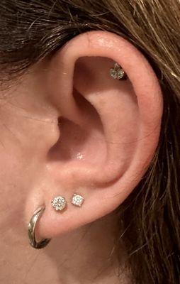 Upper helix piercing by Midori