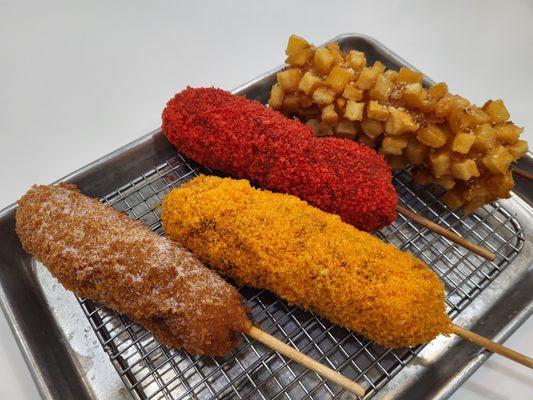 corndogs with lots of coverings like potato cubes, hot cheetos, cheese ball, churros, truffle parmesan.