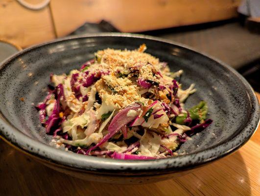 Charred Cabbage Salad. $12. Grilled tofu skin, shishito, crispy garlic, lime vinaigrette, toasted coconut.