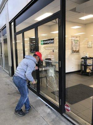 Replacing  a laminated glass for a store front  door in a professional way.