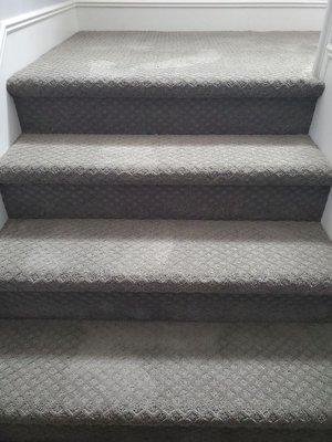 Installation of patterned carpet on stairs.