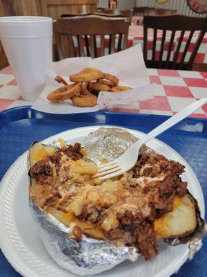 Baked potato with chopped barbecue.  Side of onion rings. And large sweet Tea.