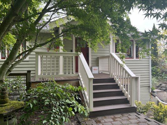 Deck Guru resurfaced our porch using Trex in "Spiced Rum"color. They built wooden railings and painted them to match the house trim.