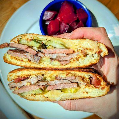 Virginia Cubano  Braised Pork & City Ham perfectly layered with pickles, mustard, and local cheese in a hot pressed sandwich.