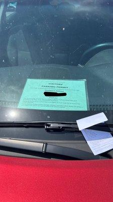 Green laminated paper is my parking pass. he left the ticket right there IN FRONT OF IT.