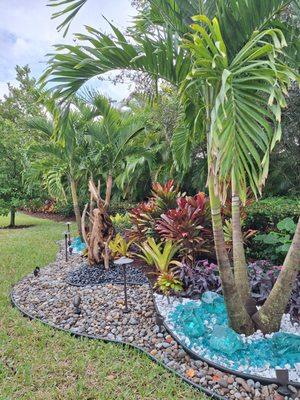 Backyard Landscape Centerpiece of a makeover. Colorful landscape design with 3 types of different stone work & glass accents ! Hope you like