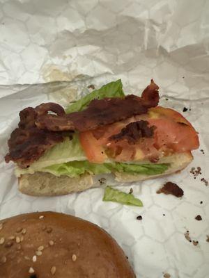 BLT Sandwich--one piece of lettuce, one half thin tomato slice and one piece burnt bacon.