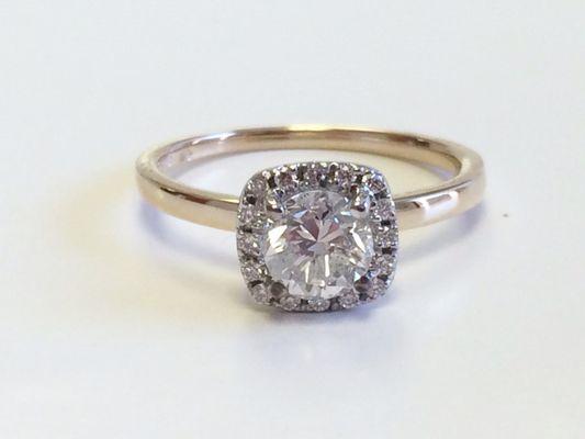 Custom two-tone 14kt round diamond center with cushion shaped halo.