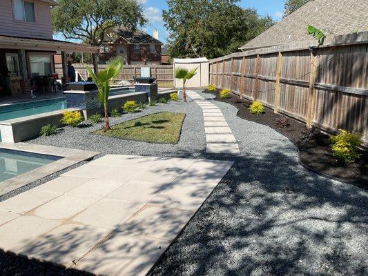 Gravel walkway with 24x24 pavers, flower beds