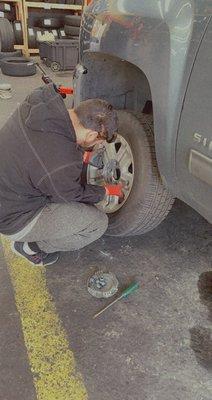 One of their awesome employees putting my tire back on after doing a rotation!