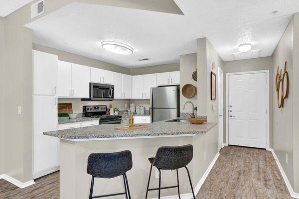 Kitchen with stainless steel appliances at Carrollton Park of North Dallas