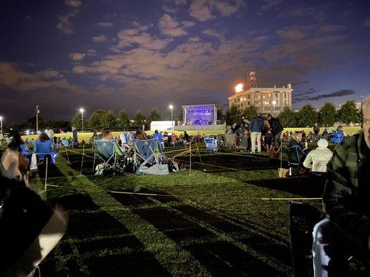 Sitting on the field watching a concert social distancing