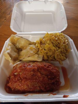 Giant stuffed cabbage, buttered noodles, and homemade potato and cheese pierogies with sauteed onions in butter.