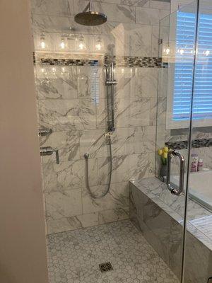 Shower with glass enclosure and towel hook