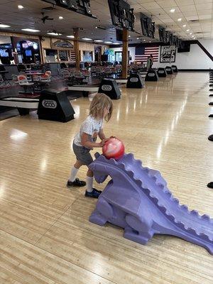 The dinosaur that kids can roll their ball down to hit the pins.