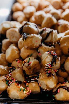 Donut holes drizzled in chocolate with sprinkles