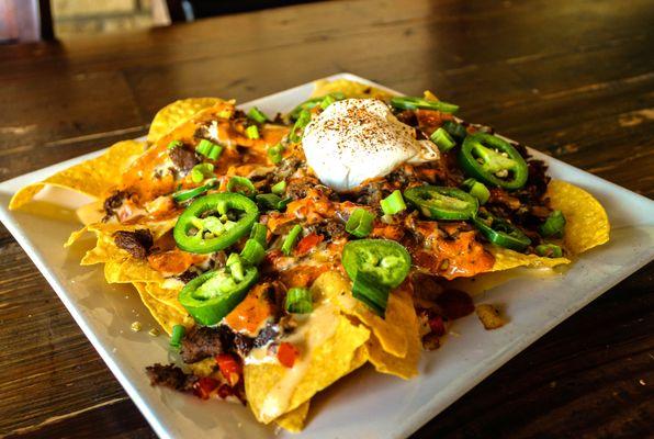 Fully Loaded Nachos with Cajun Seasoned Steak.