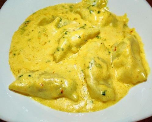 Crab meat filled housemade agnolotti in a bomb cream sauce